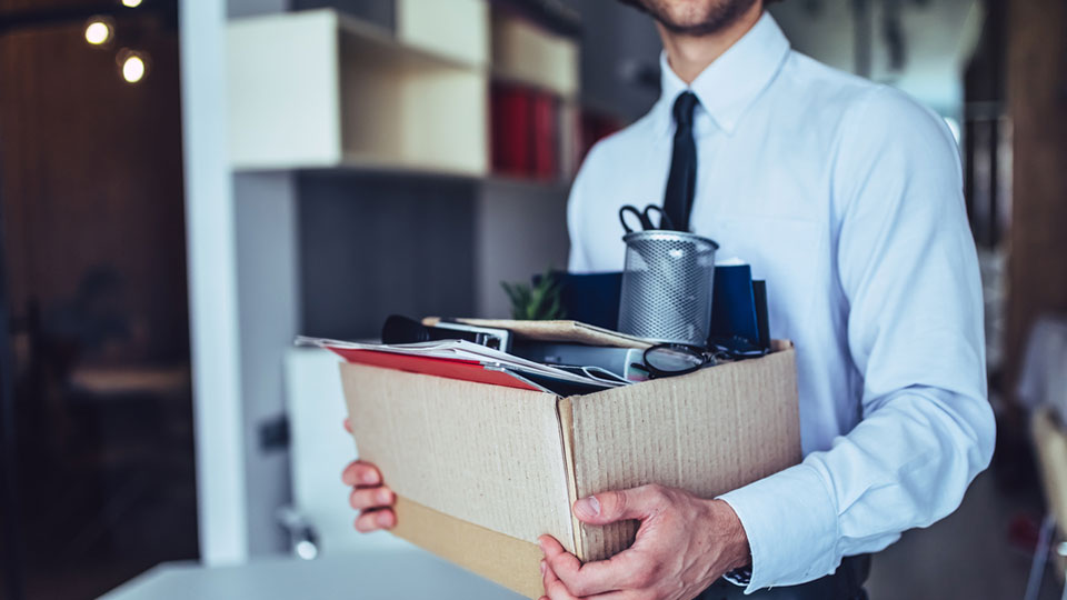 Man packing up office supplies